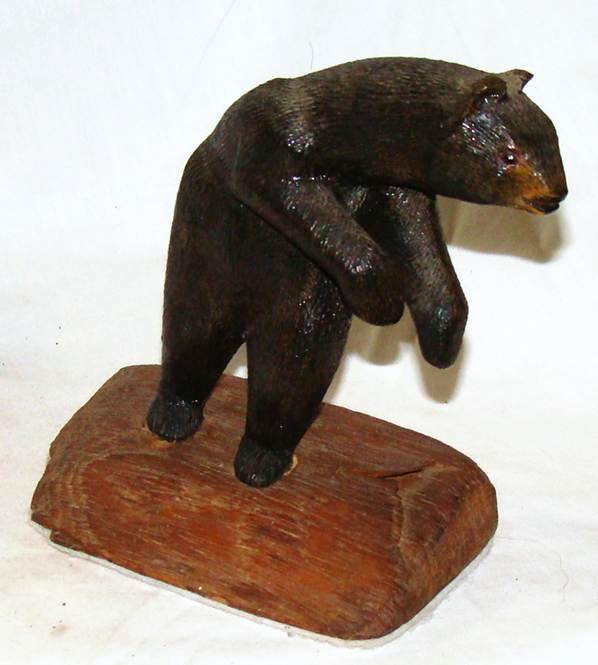 A wooden bear sculpture on a white background

AI-generated content may be incorrect.