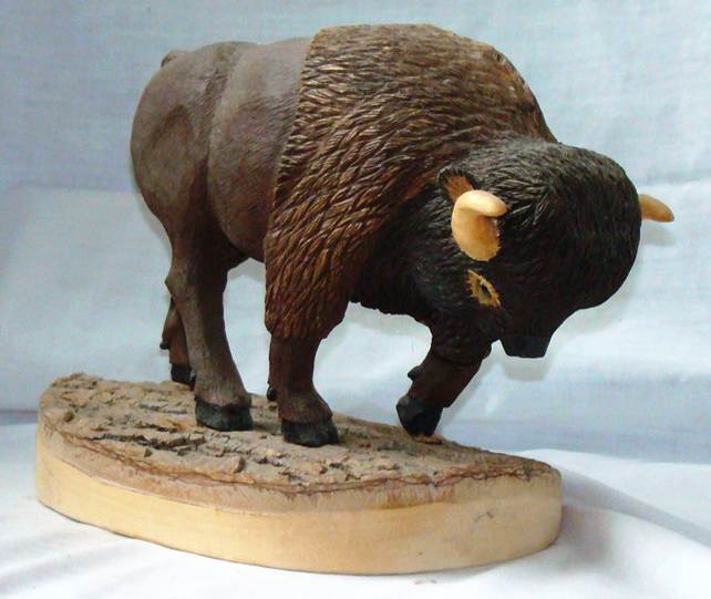 A wooden statue of a buffalo

AI-generated content may be incorrect.