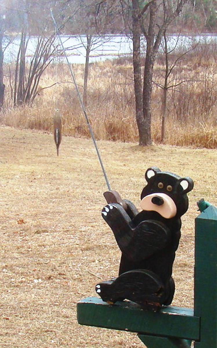 A bear statue holding an umbrella

AI-generated content may be incorrect.