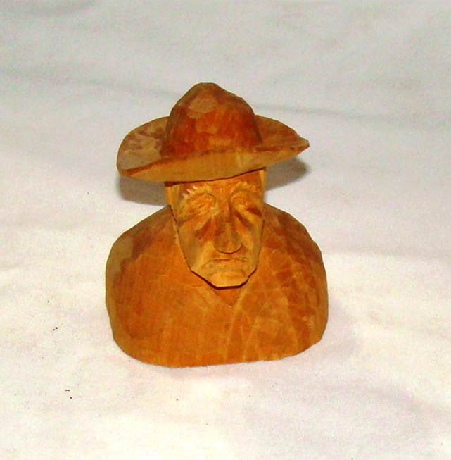 A wooden sculpture of a person wearing a hat

AI-generated content may be incorrect.