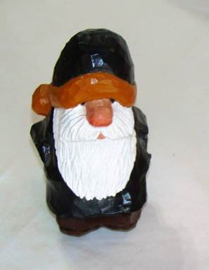 A small wooden gnome with a white beard

AI-generated content may be incorrect.