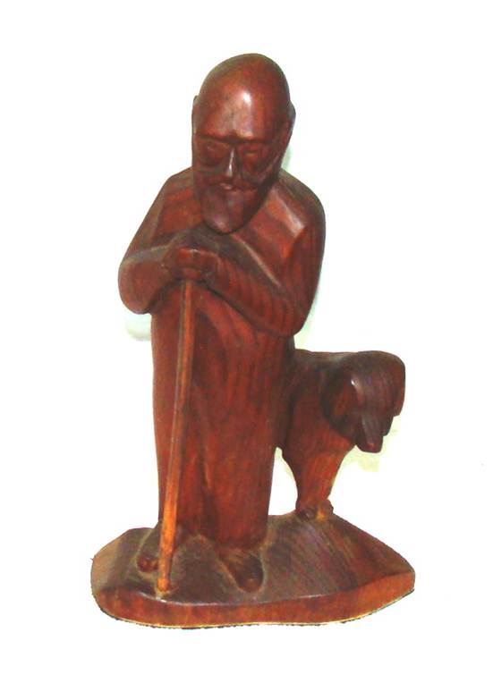 A wooden statue of a person holding a stick
AI-generated content may be incorrect.