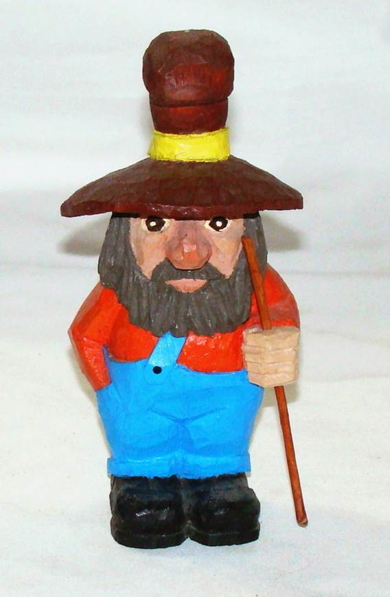 A wooden figurine of a person holding a stick
AI-generated content may be incorrect.