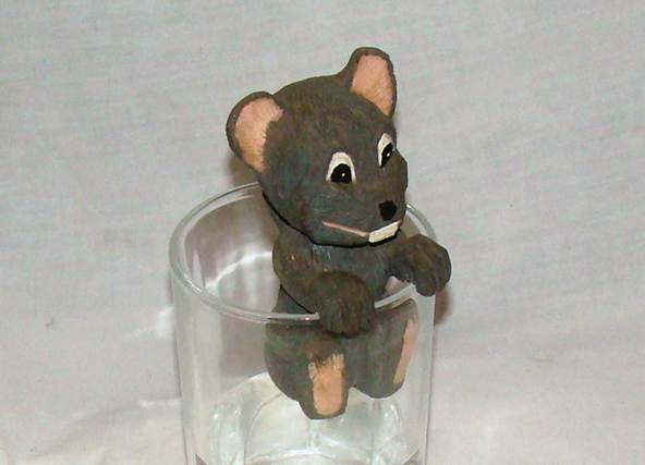 A small mouse figurine in a glass

AI-generated content may be incorrect.