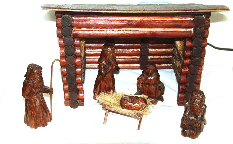 A wooden nativity scene with a manger and a manger

AI-generated content may be incorrect.