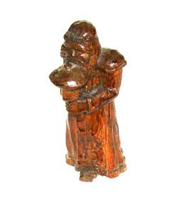 A wooden statue of a person

AI-generated content may be incorrect.