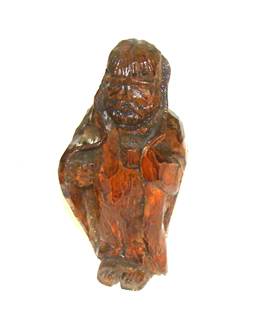 A wooden statue of a person

AI-generated content may be incorrect.