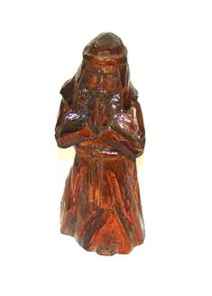 A wooden statue of a person

AI-generated content may be incorrect.