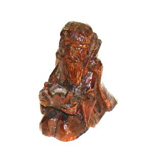 A wooden statue of a person

AI-generated content may be incorrect.