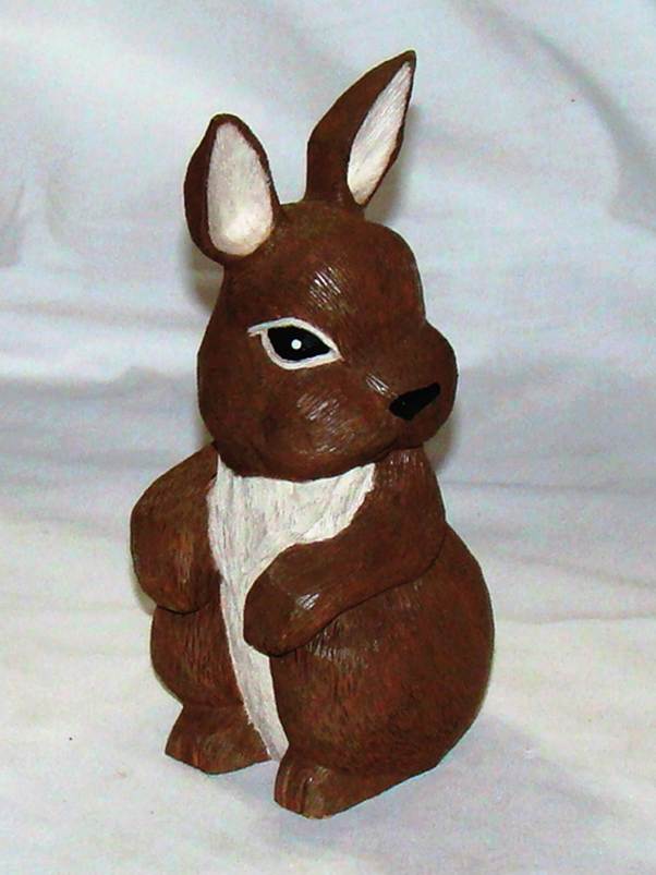 A brown rabbit statue on a white surface

AI-generated content may be incorrect.