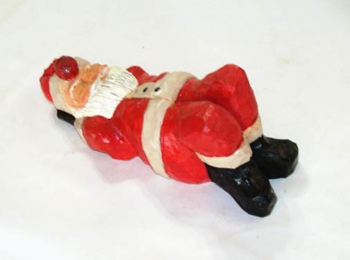 A santa claus lying on his back

AI-generated content may be incorrect.