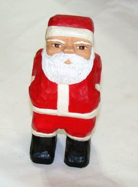 A wooden figurine of a santa claus

AI-generated content may be incorrect.