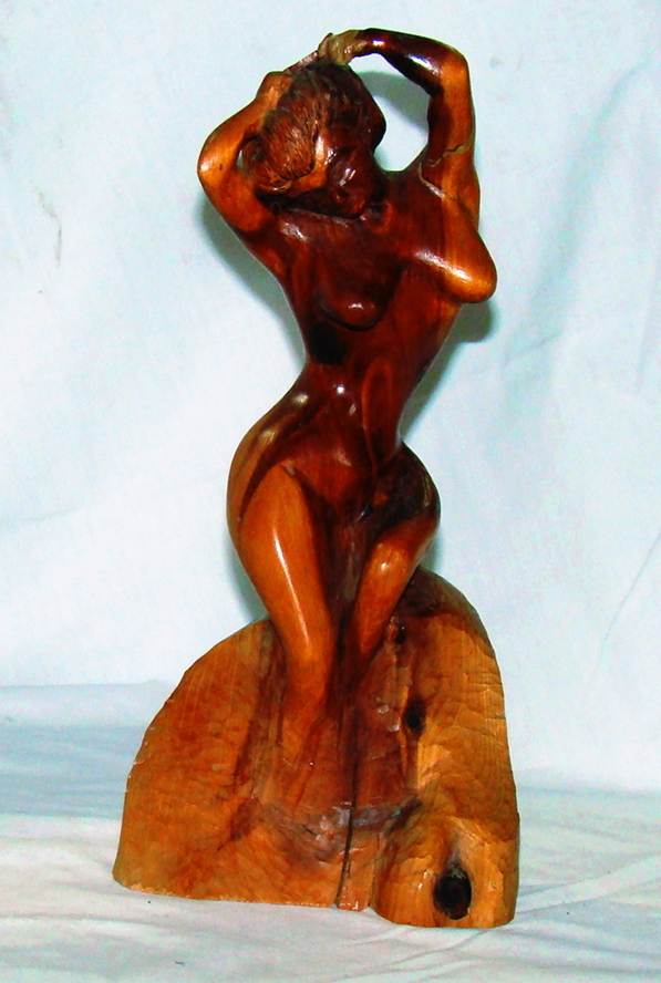 A wooden statue of a person

AI-generated content may be incorrect.