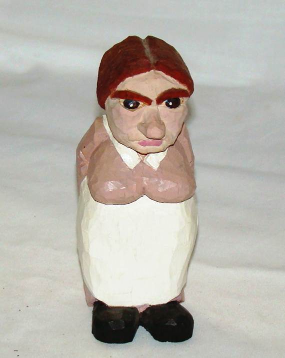 A wooden figurine of a person

AI-generated content may be incorrect.