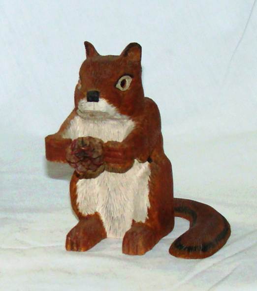 A wooden squirrel holding a pine cone

AI-generated content may be incorrect.