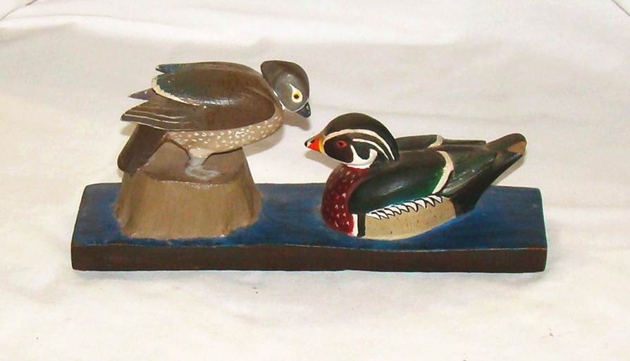 A wooden sculpture of a duck and a duck

AI-generated content may be incorrect.