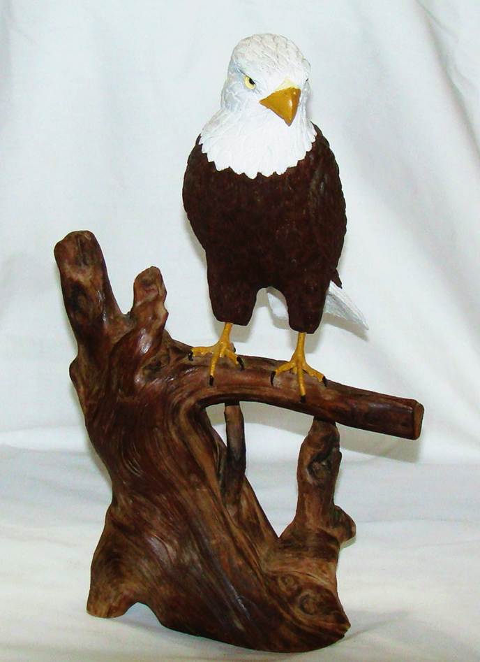 A statue of a bird on a branch

AI-generated content may be incorrect.