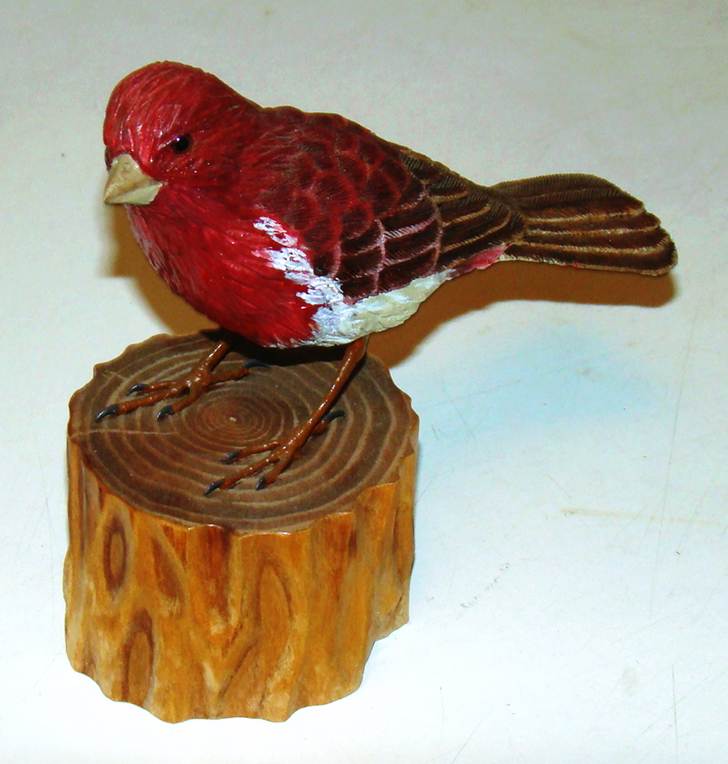A statue of a bird on a stump

AI-generated content may be incorrect.