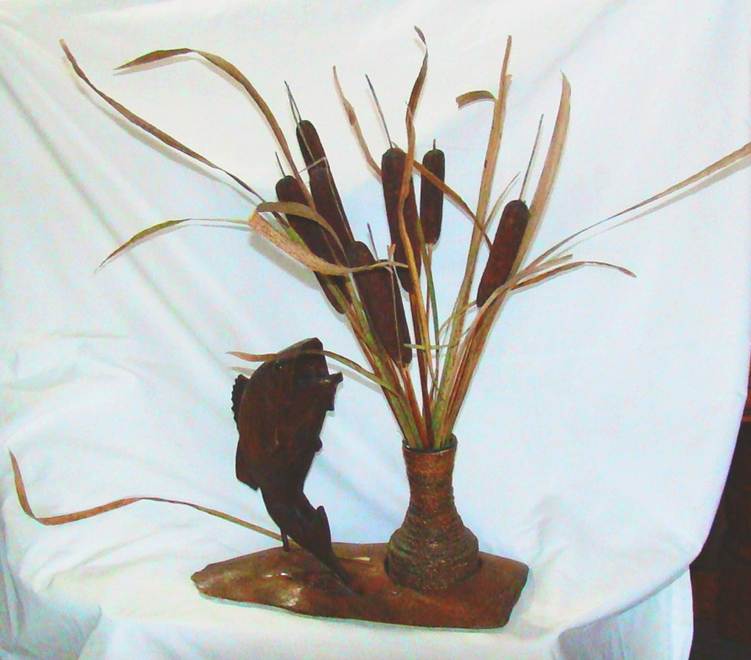 A vase with cattails and fish sculpture

AI-generated content may be incorrect.