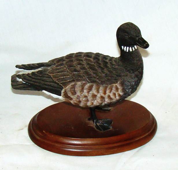 A statue of a duck on a stand

AI-generated content may be incorrect.