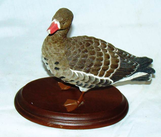 A statue of a duck on a stand

AI-generated content may be incorrect.