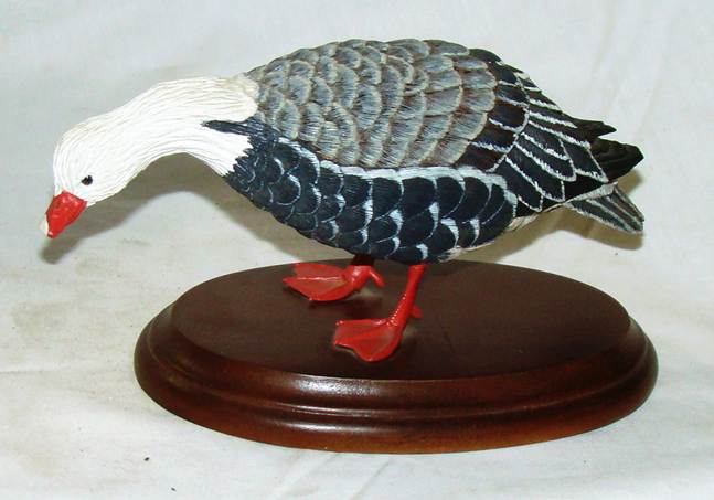 A statue of a duck on a wooden stand

AI-generated content may be incorrect.