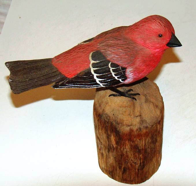 A red bird on a wood stump

AI-generated content may be incorrect.