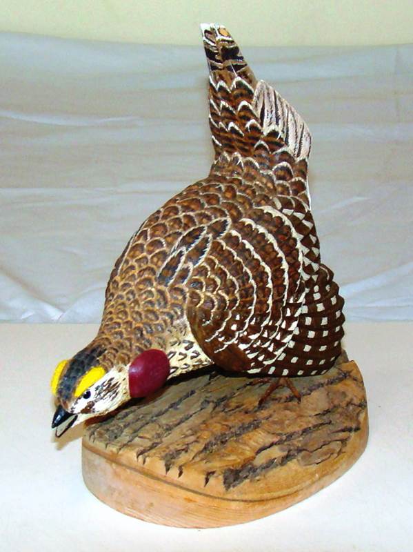 A wooden bird sculpture on a white surface

AI-generated content may be incorrect.