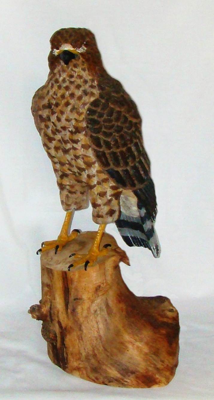 A statue of a bird on a stump

AI-generated content may be incorrect.