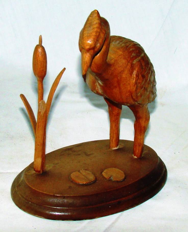 A wooden bird sculpture on a stand

AI-generated content may be incorrect.