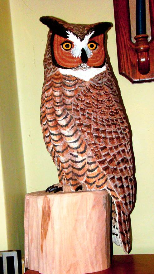 A wooden owl statue on a wood post

AI-generated content may be incorrect.