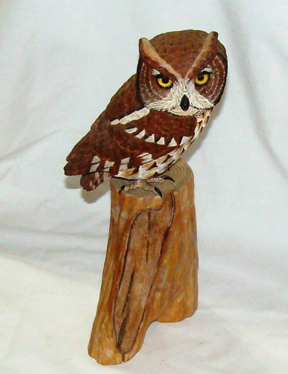 A wooden owl on a stump

AI-generated content may be incorrect.