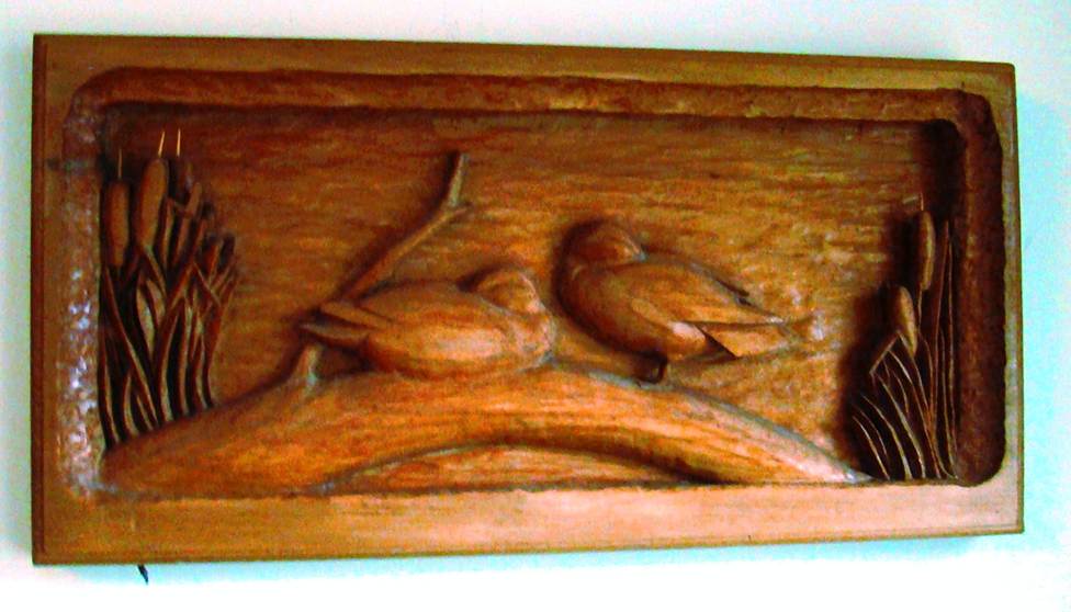 A wood carving of birds on a branch

AI-generated content may be incorrect.
