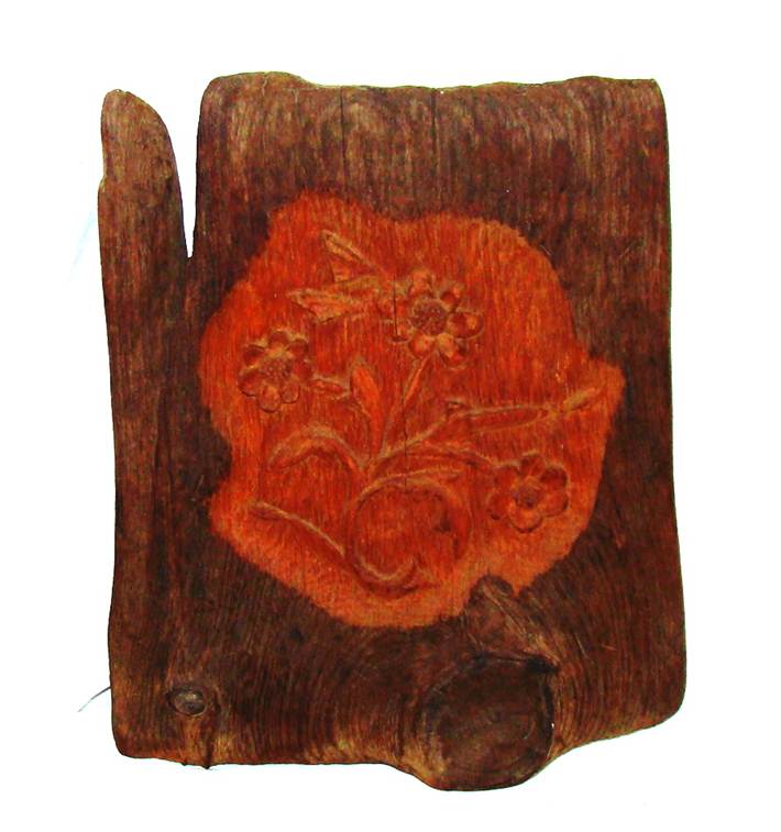A wood carving on a piece of wood

AI-generated content may be incorrect.