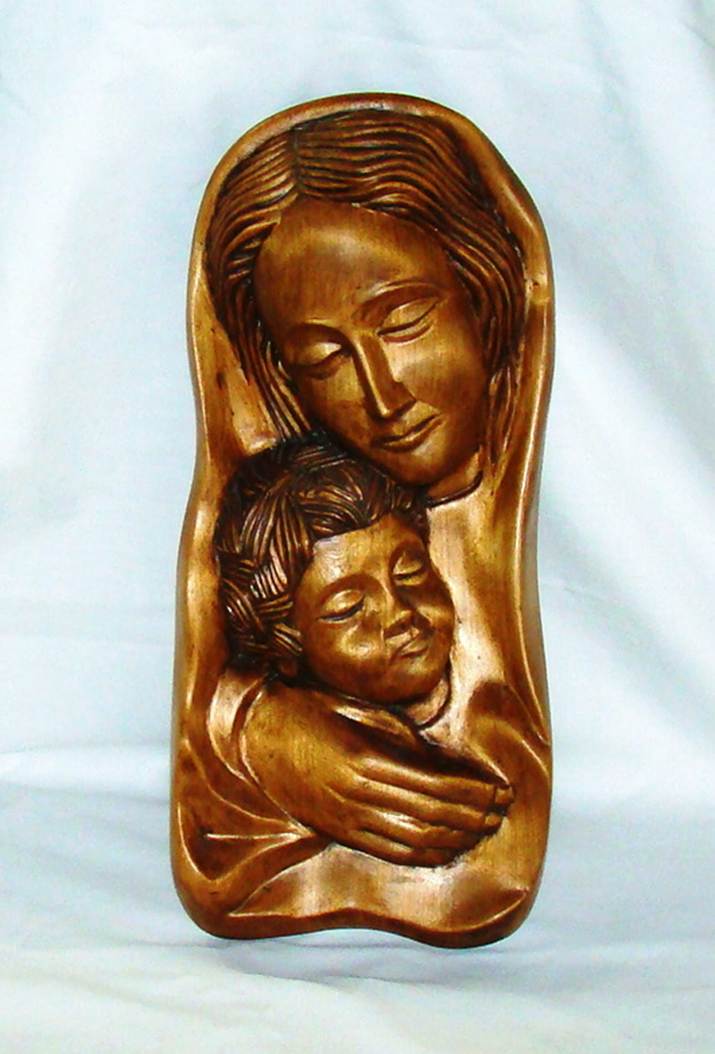 A wooden sculpture of a person and a child

AI-generated content may be incorrect.