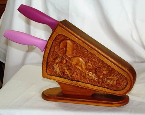 A wooden knife block with a carving

AI-generated content may be incorrect.
