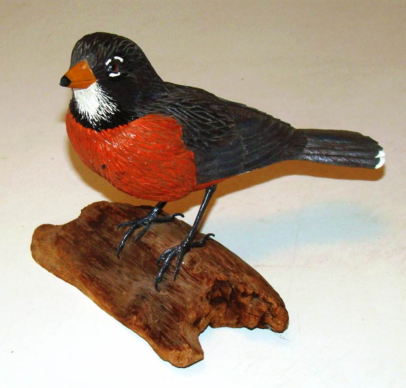 A statue of a bird on a piece of wood

AI-generated content may be incorrect.