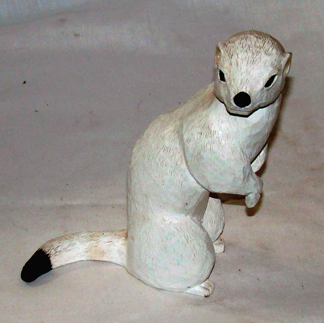 A white wood carving of a white animal

AI-generated content may be incorrect.