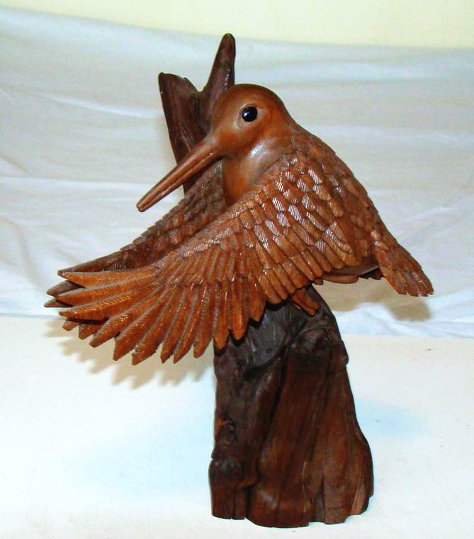 A wood carving of a bird

AI-generated content may be incorrect.
