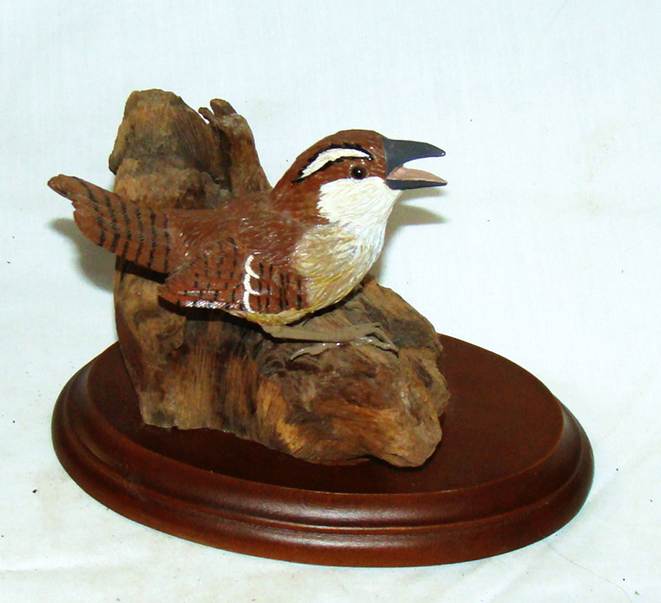 A wood carving of a bird

AI-generated content may be incorrect.
